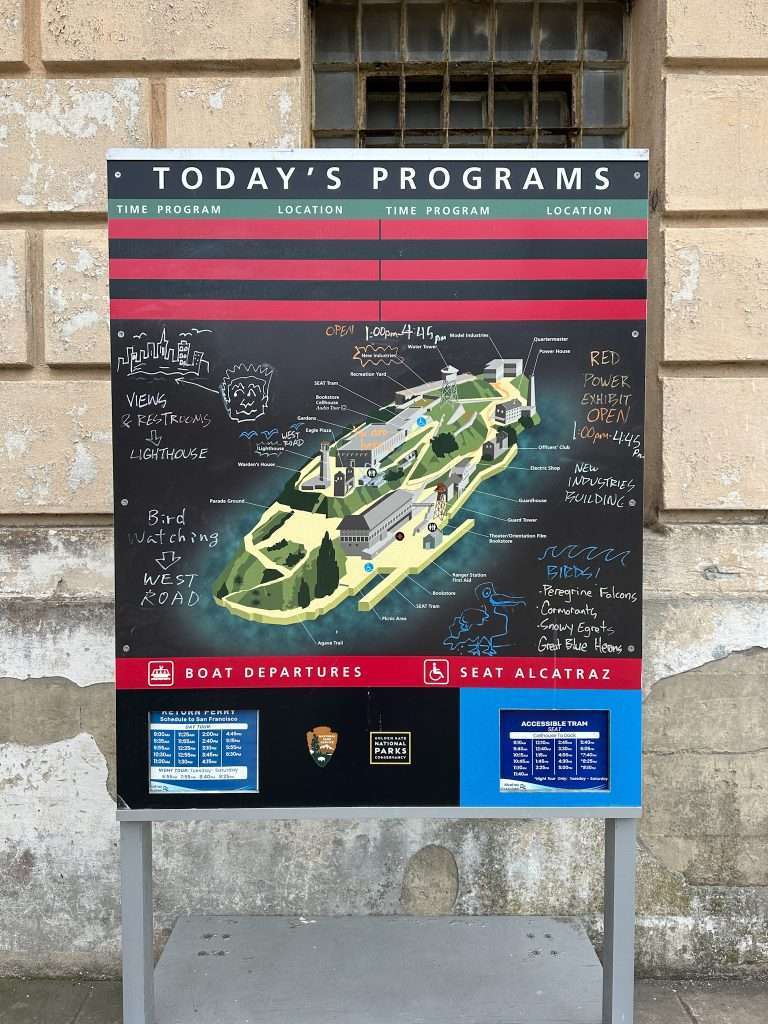 A sign outside the Alcatraz cellhouse sets out the days available activities and confirmation of return ferry times.
