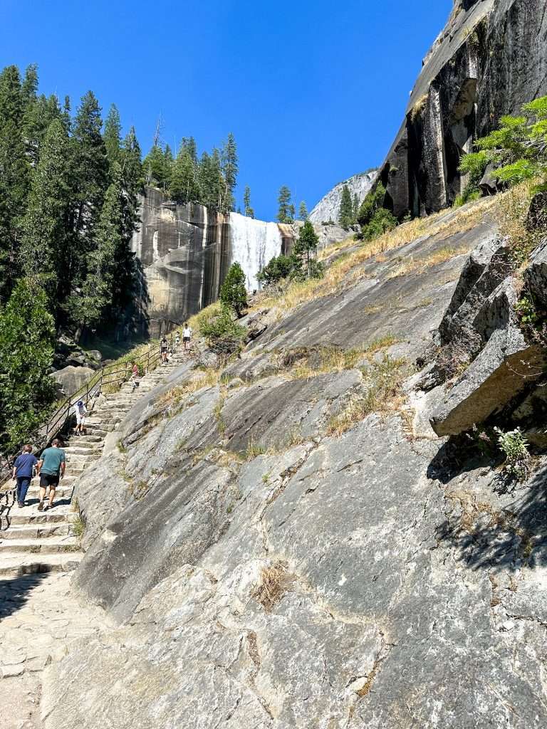 Image shows the Mist Trail in Yosemite National Park with some of the 600+ stone steps and part of Vernal Falls visible.