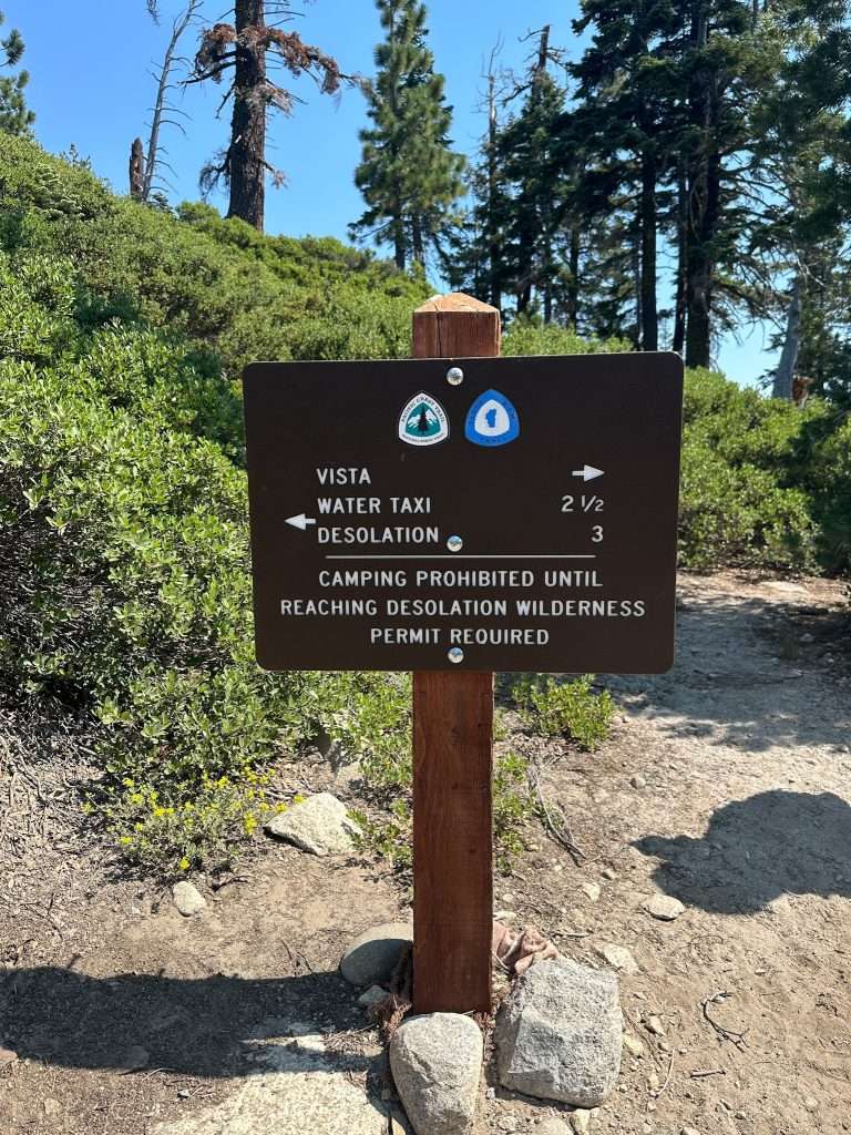 A sign at the start of the Echo Lakes Trail with directions toward a view over the Lake Tahoe area and directions toward a water taxi and Desolation Wilderness in the other direction.