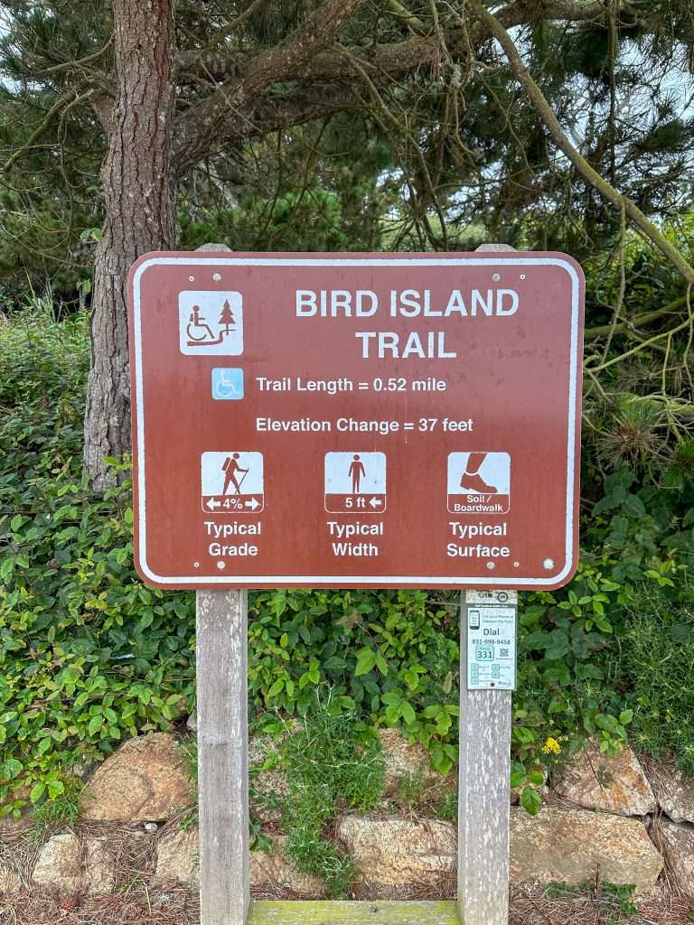 Image shows signage at the Bird Island Trailhead and provides information as to length of trail, elevation change and typical surface.