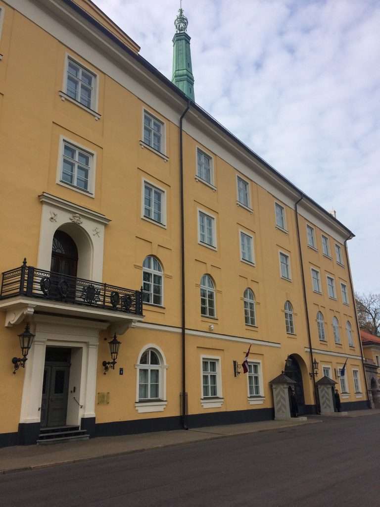 Image shows a side view of the yellow coloured Riga Castle, home to the Latvian president.