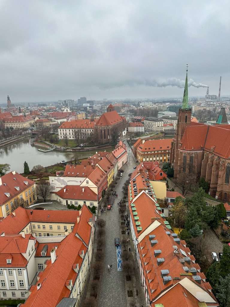 Images shows the view looking down from one of the Cathedral towers along the street leading to the cathedral. The orange coloured roofs of the surrounding buildings stand out on a cold December day!