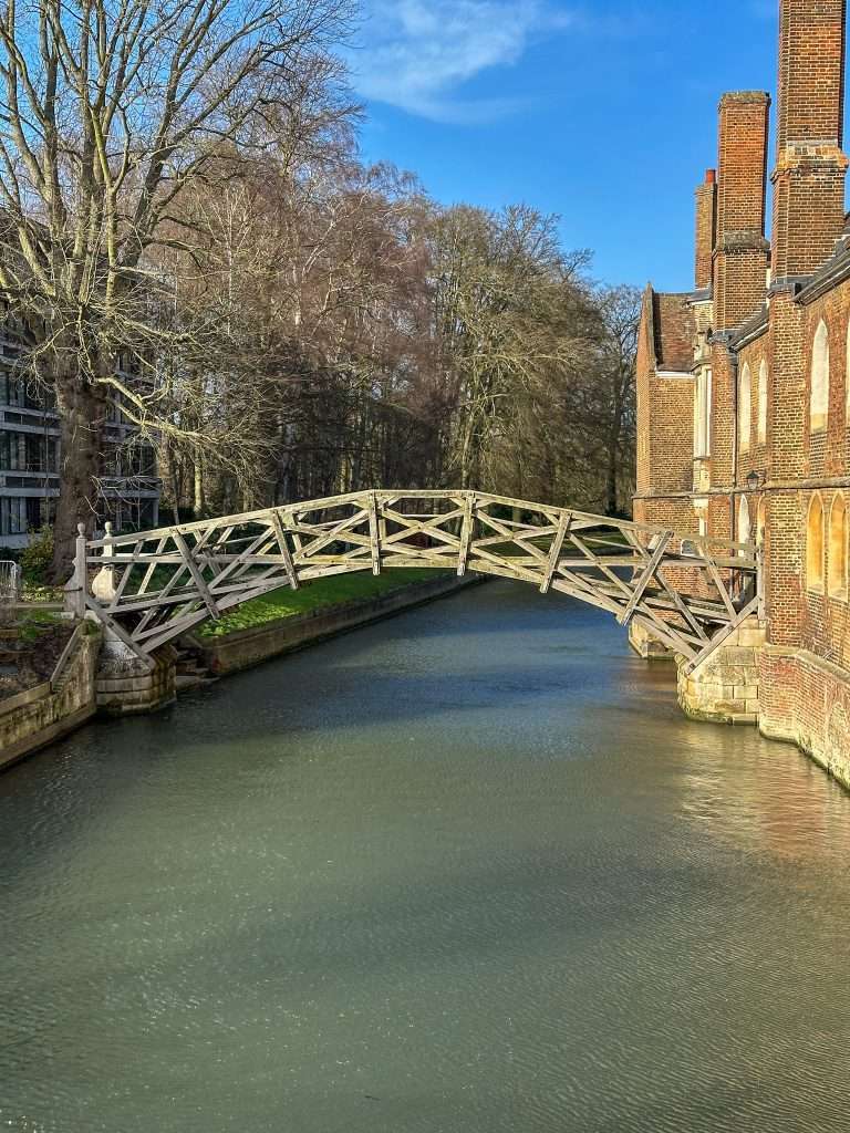 View of the wooden Mathematical Bridge, part of Queen's College in Cambridge England, as seen from the Silver Street Bridge