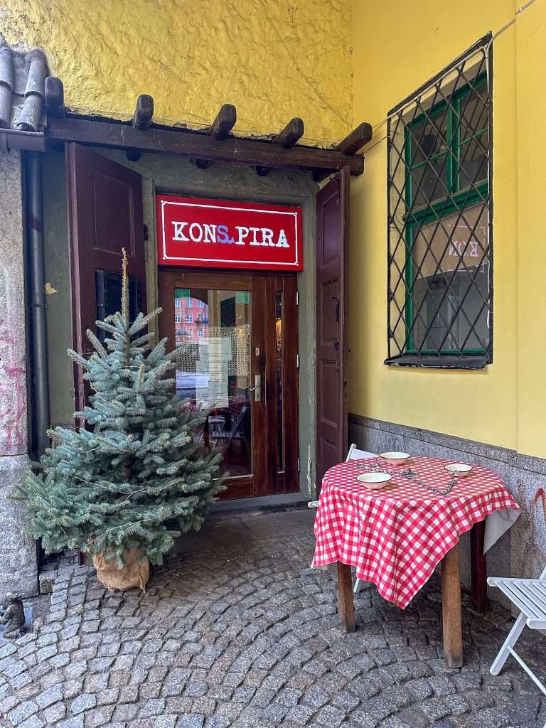 Image shows an external view of the restaurant known as Konspira in Wroclaw Poland. Great food and an interesting story make it a must stop place when visiting the city. 