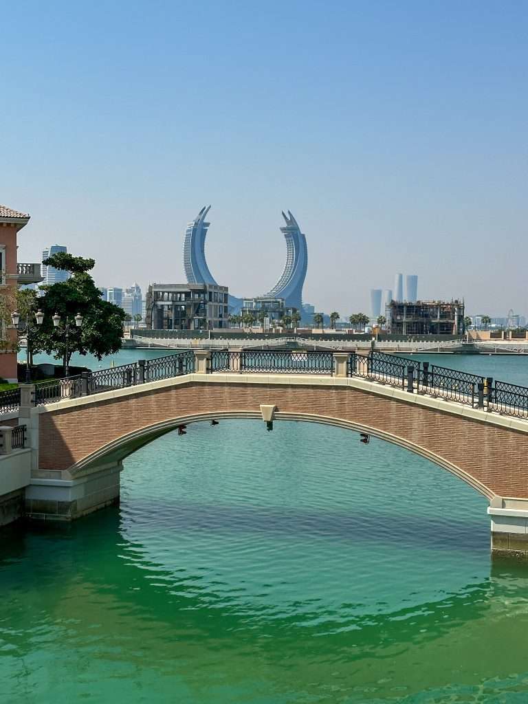 A view of the Venice inspired canal of the Qanat Quartier with a view toward the Lusail area and the crescent shaped Katara Towers.