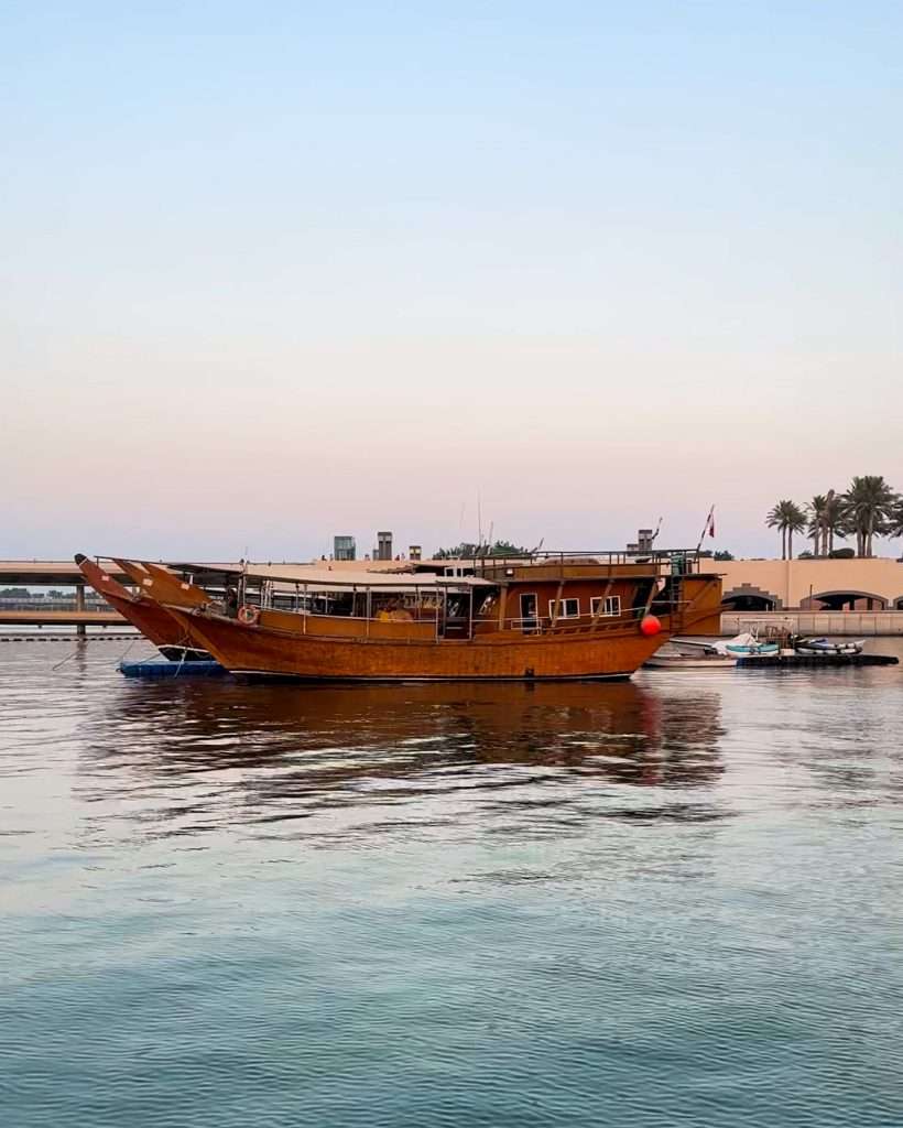 A traditional wooden dhow lies at anchor in Doha Bay.